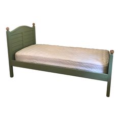 a green bed frame with white sheets on top and bottom, in front of a white background