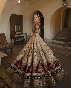 a woman in a wedding dress standing on the floor