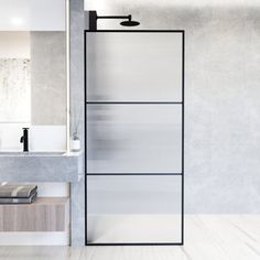 a bathroom with a sink, mirror and towel rack in the middle of the room