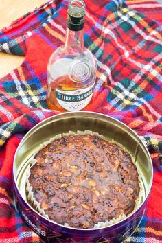 there is a cake in the pan and a bottle on the table next to it