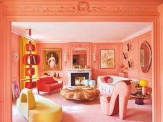 a living room with pink walls and furniture