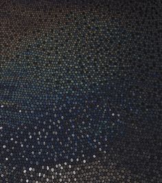 a black and blue mosaic tile with white dots on it's surface is shown