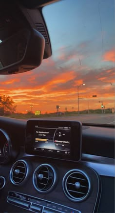 the dashboard of a car at sunset