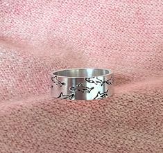 Adjustable size 7-9 Shark Ring measures 6.3mm x 57mm and is 18 gauge thick. Hand stamped (note no two rings will look exactly alike).  This ring is made out of aluminum.  Aluminum jewelry is: 1. It's light weight 2. It's Hypoallergenic 3. It doesn't Rust 4. It Doesn't Tarnish  5. Aluminum is easy to clean 6. It's Eco Friendly 7. It looks like Sterling Silver Comes in gift box with a cleaning cloth. Shark Lover Gifts, Whale Shark Jewelry, Shark Bracelet, Shark Rings Jewelry, Whale Ring Silver, Shark Ring, Shark Jewelry, Fish Ring, Shark Lover