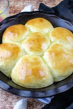 a pan filled with bread sitting on top of a table next to a glass bowl