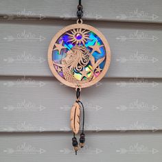 a wooden dream catcher hanging on the side of a building