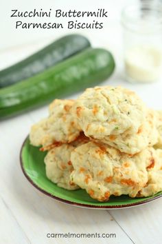 a green plate topped with cookies next to cucumbers