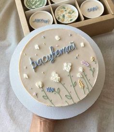 a cake in a box with the word bacopherna written on it next to some plates