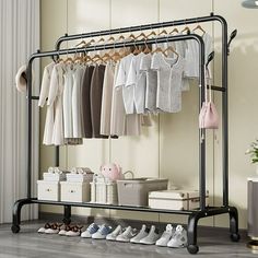 an iron rack with clothes and shoes on it