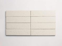 a white brick wall that is made out of cement bricks and has four smaller blocks on each side