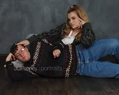 a man laying on the floor next to a woman