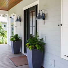 two large planters are on the front porch