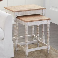 two wooden tables sitting next to each other on top of a white couch in a living room