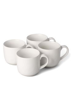 four white coffee cups sitting next to each other