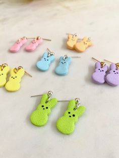 the small earrings are made out of clay and have bunny ears on each earring