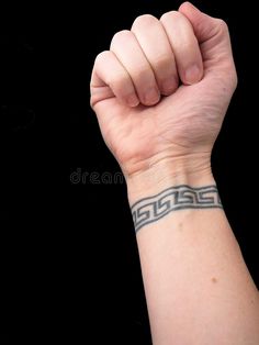 a woman's arm with a tattoo on it and a fist raised up in the air