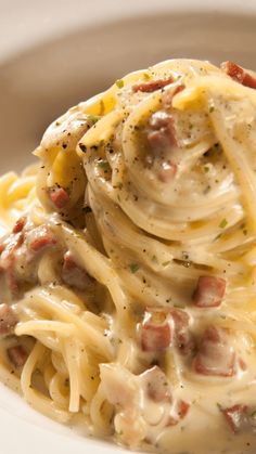 a white plate topped with pasta covered in sauce