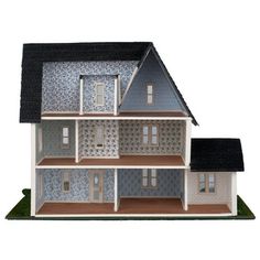 a model house with blue and white sidings on the front, black roof and windows