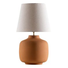 an orange ceramic table lamp with a white linen shade on the top and bottom part