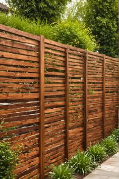 a wooden fence in the middle of a garden