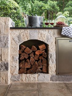 an outdoor fireplace with logs in it