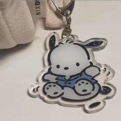 a key chain with an image of a cartoon character holding a teddy bear on it