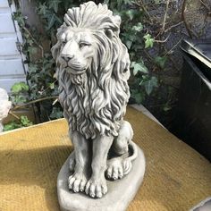 a statue of a lion sitting on top of a table