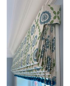 an image of a window curtain with beads hanging from it's valances