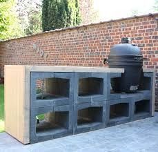 a bbq grill built into the side of a brick wall in a back yard