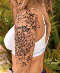 a woman's arm with flowers on it, and the back of her body