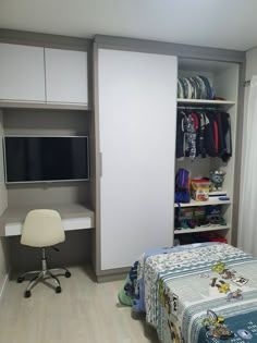 a bedroom with a bed, desk and television in it's closet area next to a sliding glass door