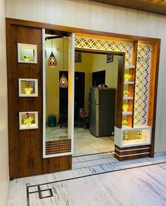 an open door to a kitchen with pictures on the wall