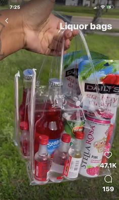 a person holding a plastic bag filled with drinks