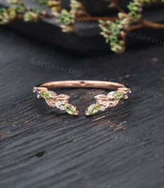 a close up of a ring on a wooden surface with plants in the background and text overlay