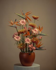 a vase filled with lots of flowers on top of a table