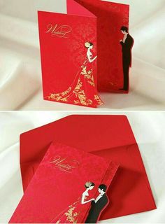 the wedding card is red and gold with a bride and groom in black on it