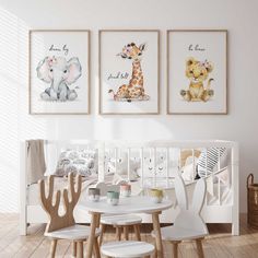 a baby's room with three pictures on the wall