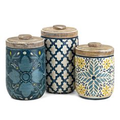 three jars with designs on them sitting next to each other