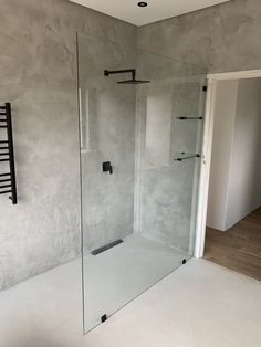 an empty bathroom with a glass shower door