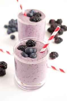 two glasses filled with blueberries and blackberries on top of each other