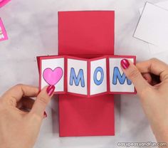 someone is making a card with the word mom