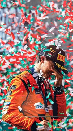 a man in an orange jacket surrounded by confetti