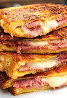 a stack of pancakes with ham and cheese