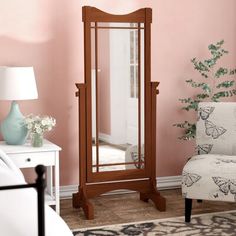 a mirror sitting on top of a wooden floor next to a white chair and table