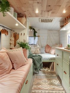 the interior of a small camper is decorated in pastel green and pinks