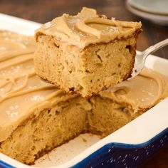 two pieces of cake with frosting in a blue and white dish