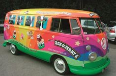 a brightly colored bus is parked in a parking lot