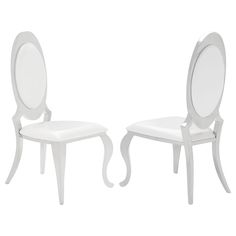 a pair of white chairs with oval mirrors on the back and sides, facing each other