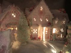 a doll house is lit up with christmas lights