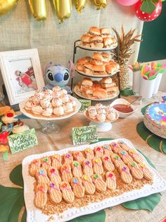 a table topped with lots of cookies and desserts